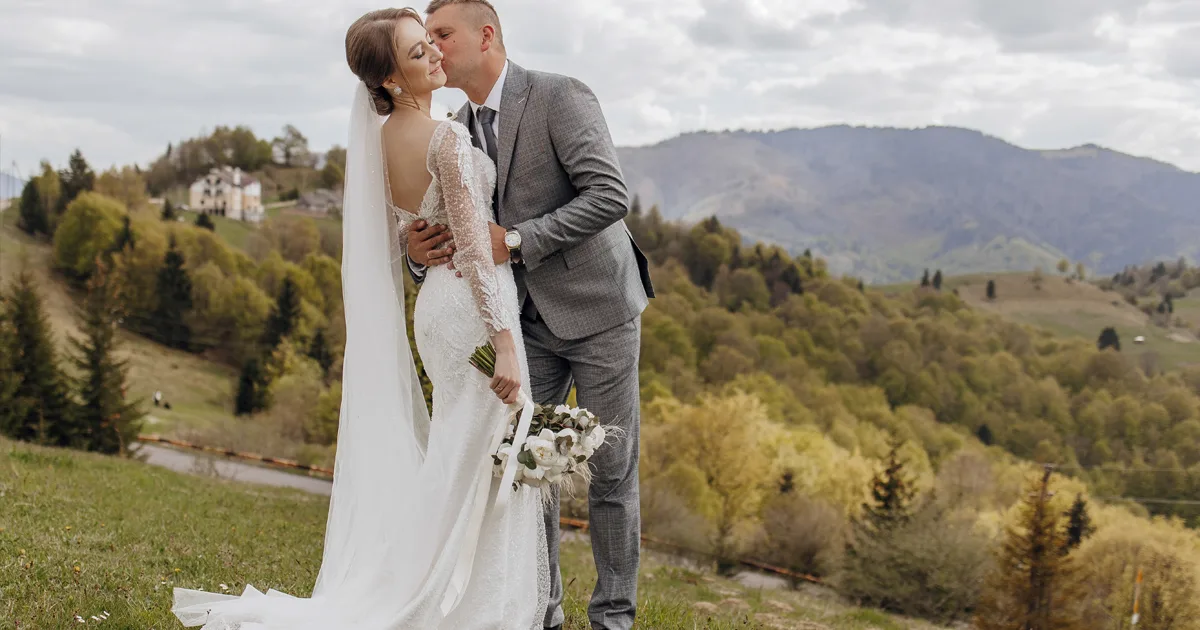 Couple eloping in Mallorca on a dramatic clifftop with the Mediterranean sea stretching to the horizon